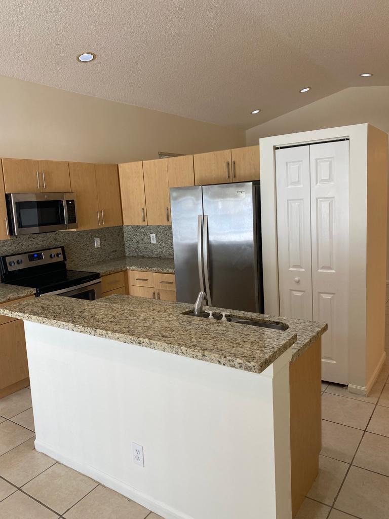 A single-story house with a tan exterior, tile roof, and a two-car garage — 1968 SW 177th Avenue, Miramar FL 33029, MIRAMAR, FL