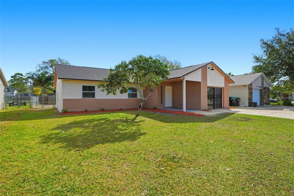 A single-story house with a brick facade, a covered entryway, and a large front lawn — 2843 CALICO COURT, ORLANDO, FL