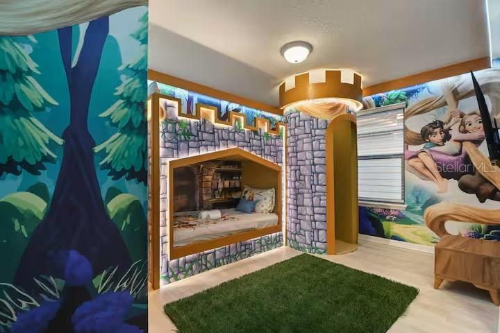 A themed bedroom features a castle-style bunk bed, Rapunzel wall murals, and a green rug — 2321 LUXOR DRIVE, KISSIMMEE, FL