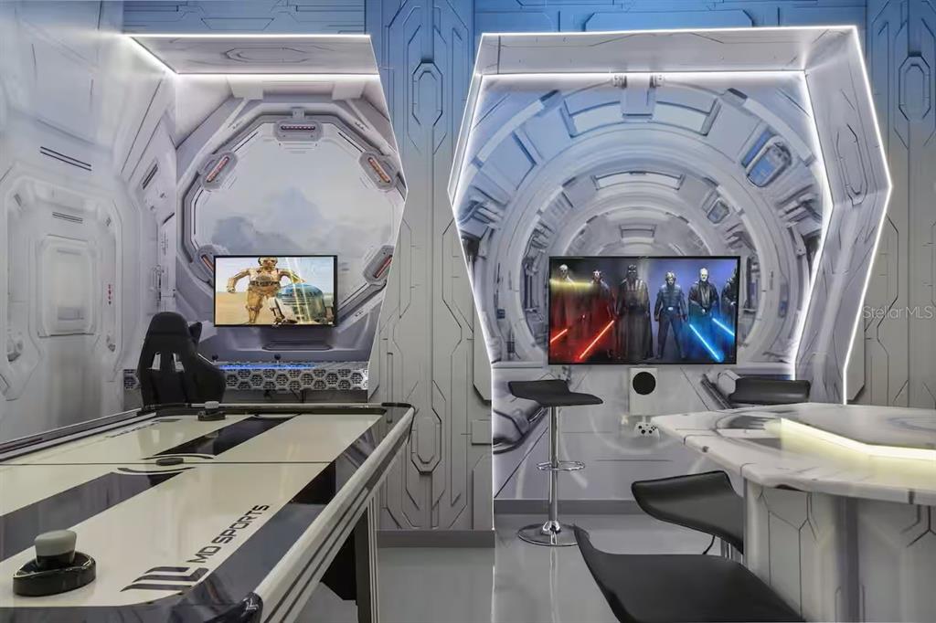 A Star Wars-themed game room featuring an air hockey table, gaming consoles, and futuristic decor — 2321 LUXOR DRIVE, KISSIMMEE, FL