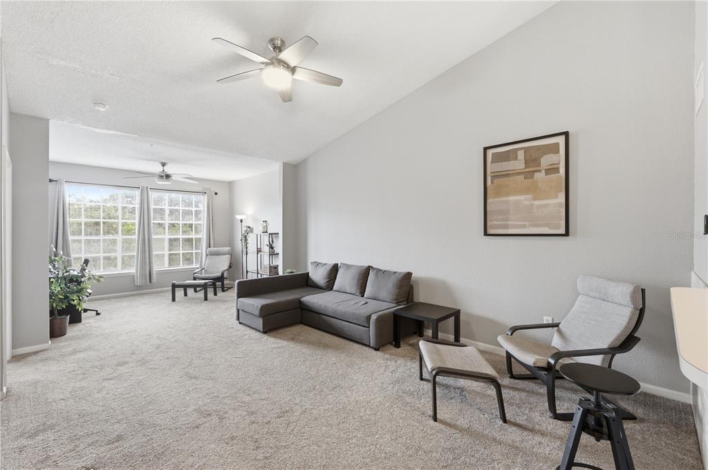 A living room features a grey sectional sofa, two armchairs, and a ceiling fan — 13001 MULBERRY PARK DRIVE UNIT 132, ORLANDO, FL