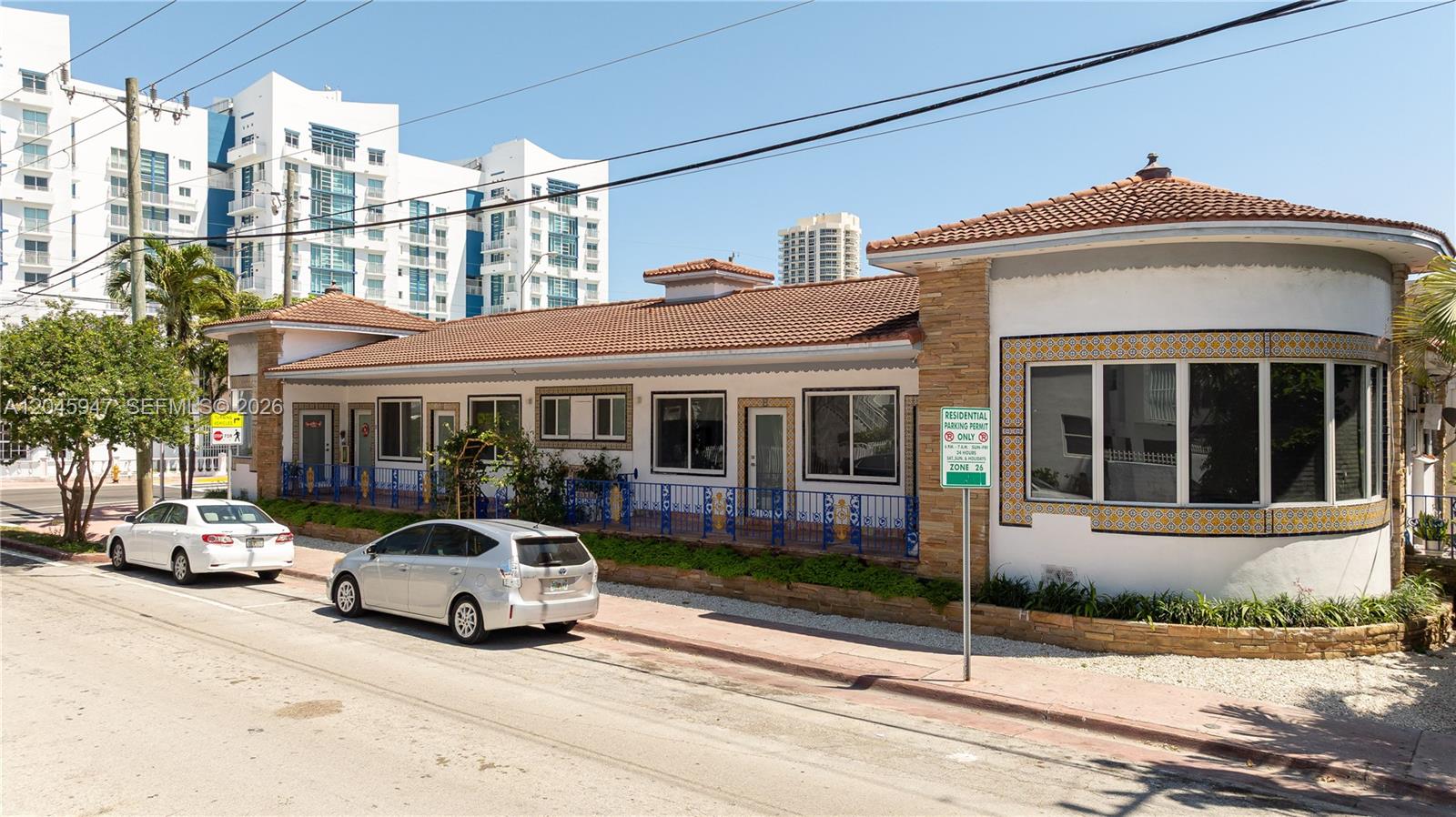 A single-story building with a tiled roof and a curved corner section sits curbside — 7640 Harding Ave, Miami Beach FL 33141, MIAMI BEACH, FL