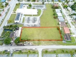 An aerial view shows a vacant rectangular lot outlined in red within a residential area — 1855 NW 119th St, Miami FL 33167, MIAMI, FL