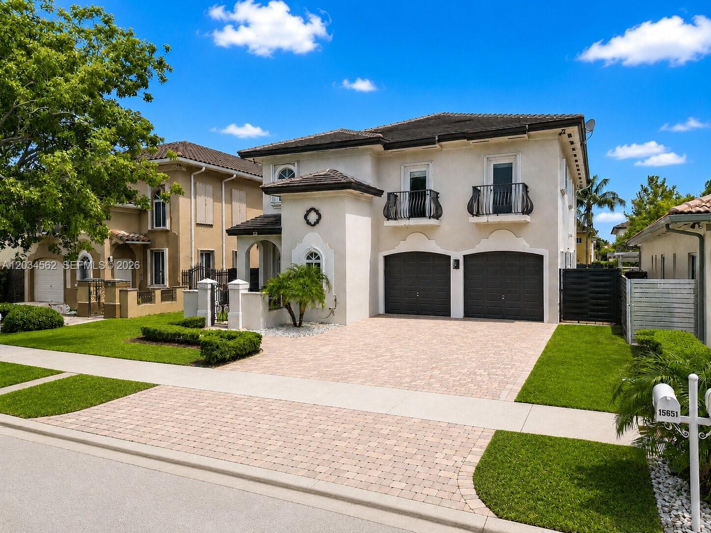 An aerial view shows a residential neighborhood with houses, swimming pools, and a central lake — 15651 SW 14th St, Miami FL 33194, MIAMI, FL