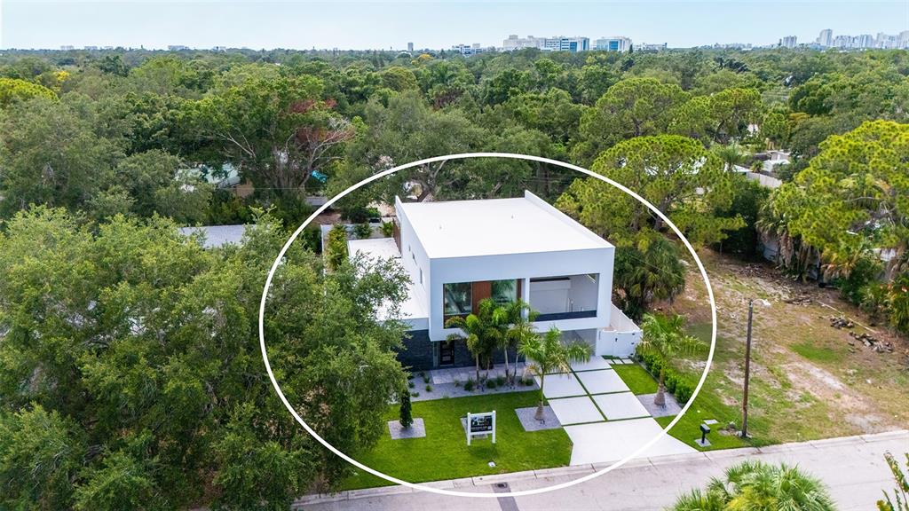 A modern two-story house features a white facade, stone accents, and a landscaped front yard — 2050 EUCLID TERRACE, SARASOTA, FL