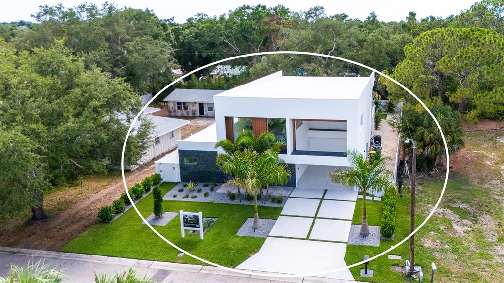 A modern two-story white house features a swimming pool and patio in the backyard — 2050 EUCLID TERRACE, SARASOTA, FL