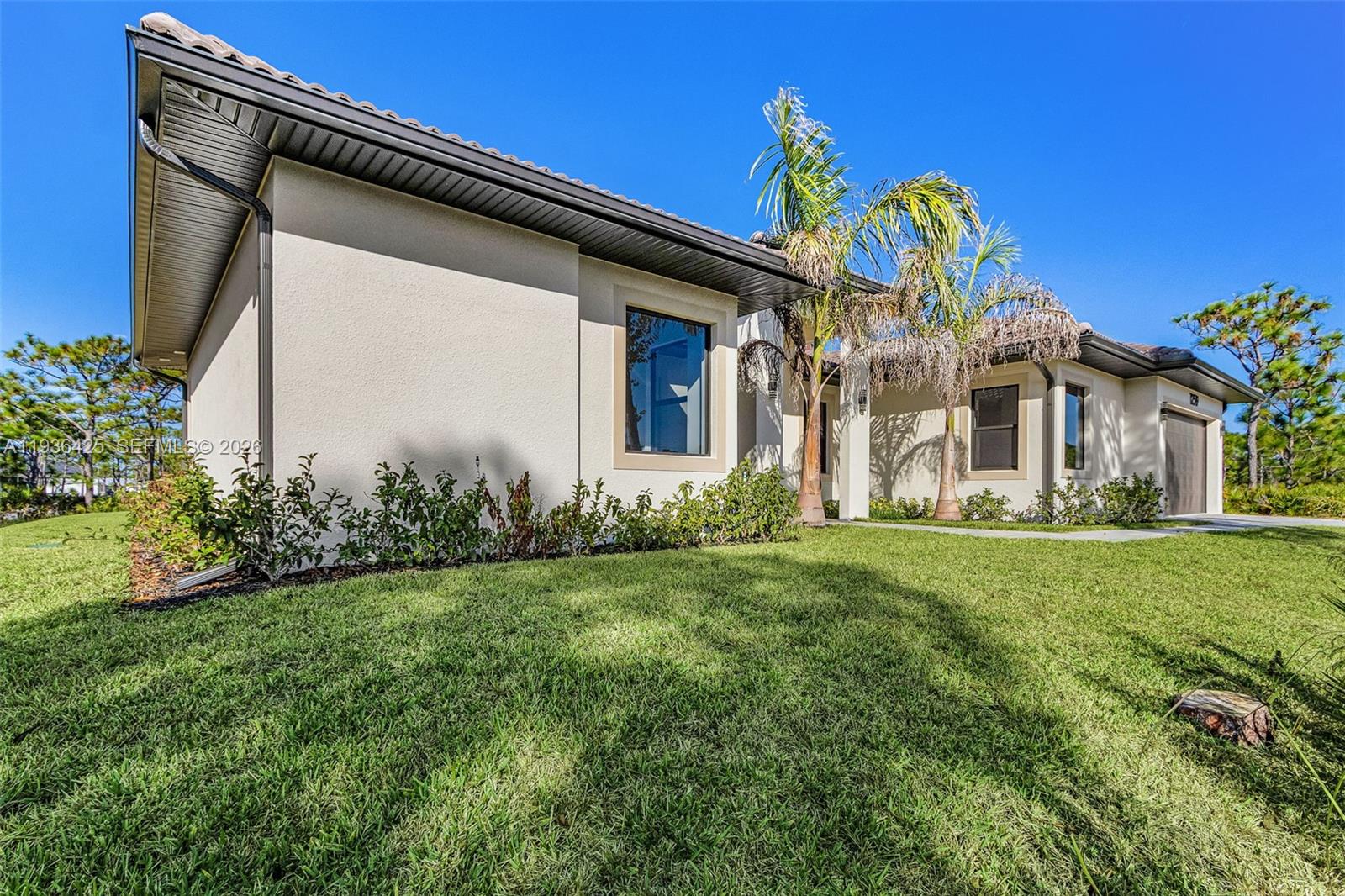 A single-story house with a beige stucco exterior, a tiled roof, and palm trees — OTHER CITY - IN THE STATE OF FLORIDA, FL