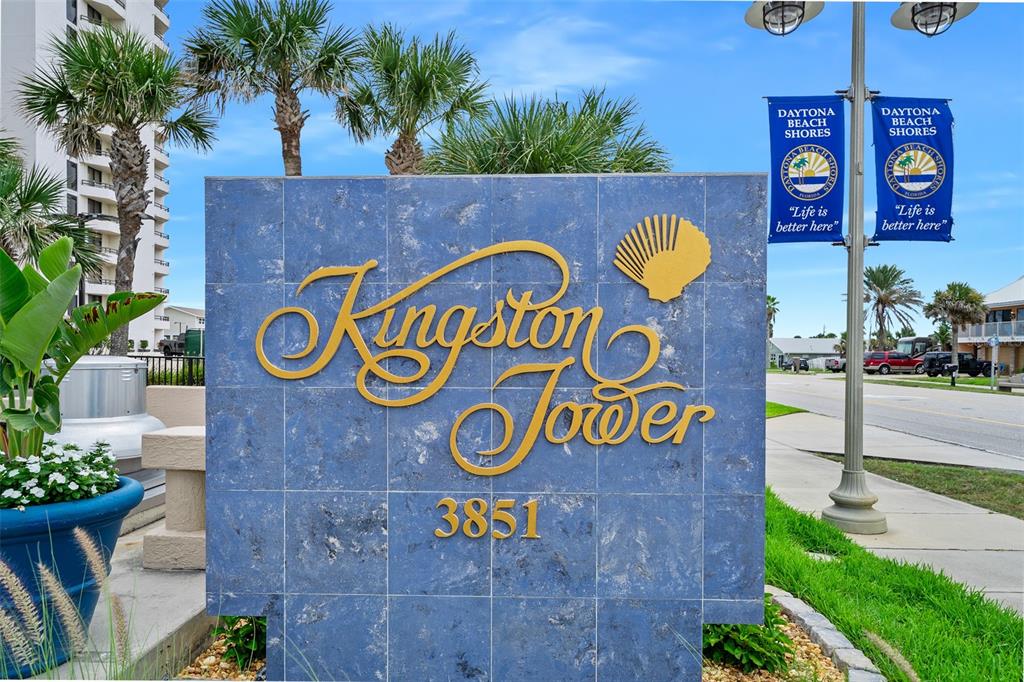 A blue stone sign with gold lettering identifies the Kingston Tower building — 3851 S ATLANTIC AVENUE UNIT 701, DAYTONA BEACH, FL