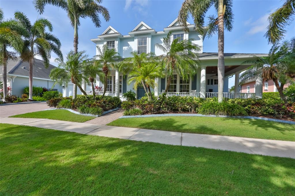 An aerial view shows a waterfront house with a screened pool and a private dock — 5318 LOON NEST COURT, APOLLO BEACH, FL