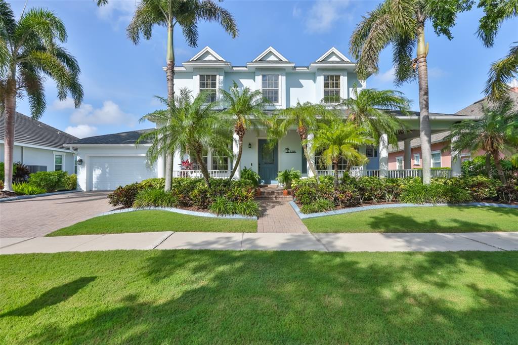 A front porch with white columns, a blue door, and a brick walkway — 5318 LOON NEST COURT, APOLLO BEACH, FL