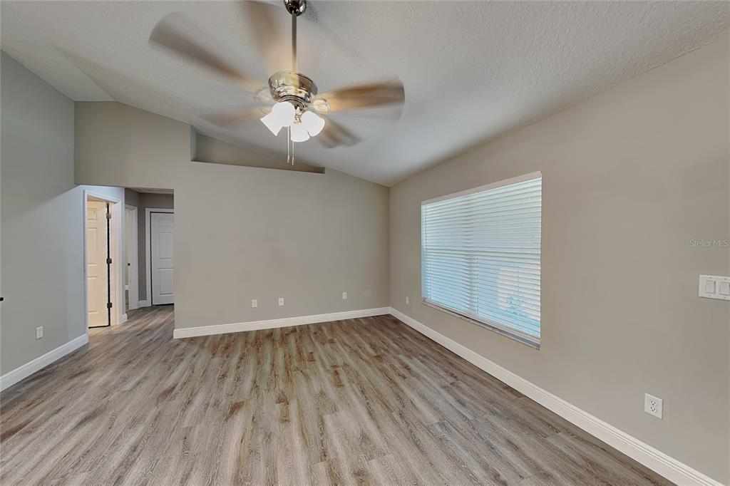 An empty room with light gray walls, wood-look flooring, and a ceiling fan — 7961 N PRIMROSE DRIVE, CITRUS SPRINGS, FL
