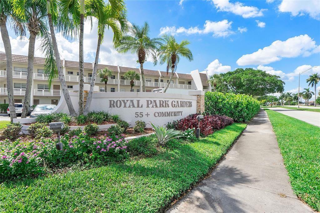 The exterior of a multi-story apartment complex features a prominent sign for Royal Park Gardens — 6890 Royal Palm Boulevard # 312h, Margate FL 33063, MARGATE, FL