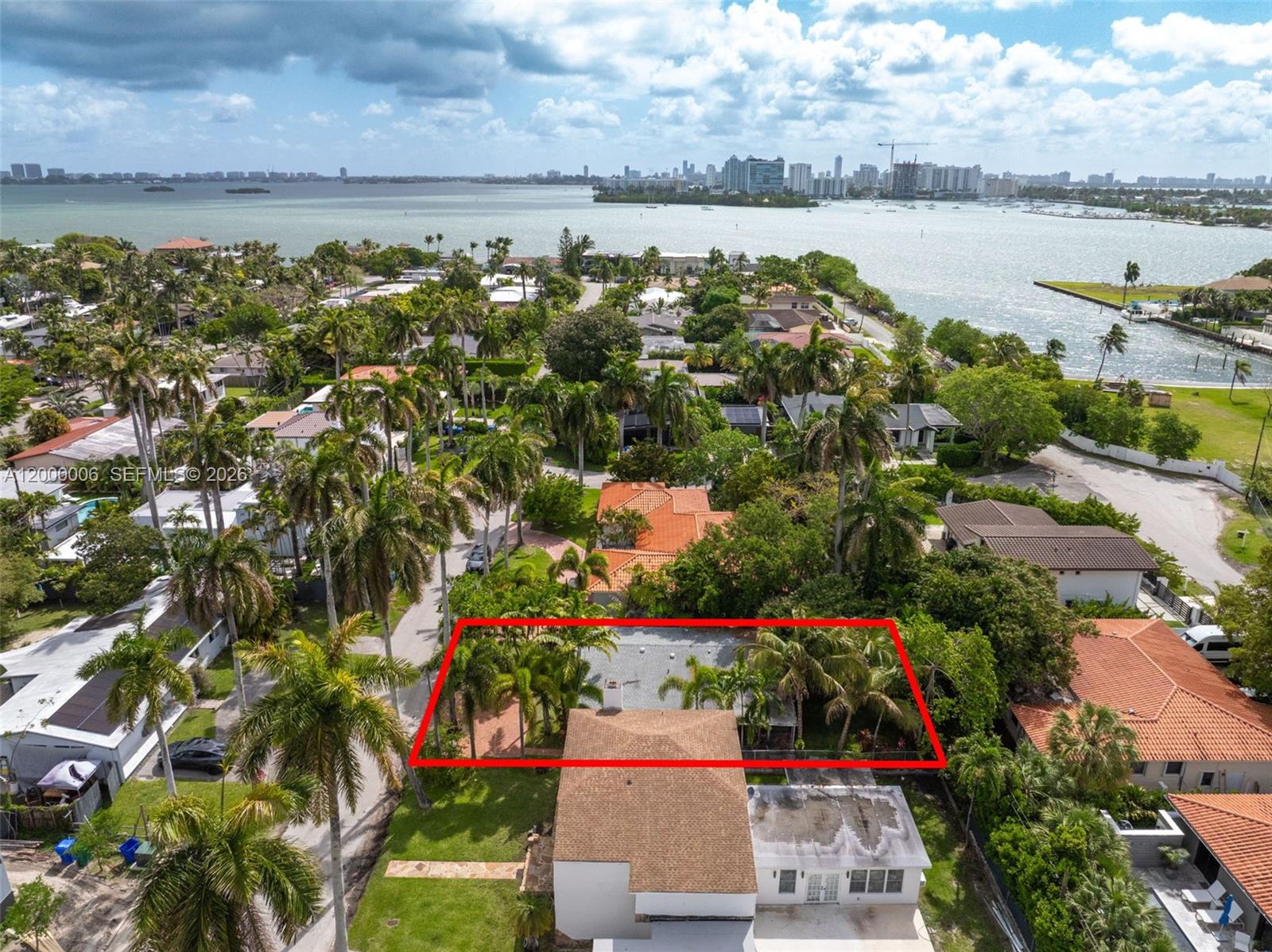 An aerial view shows a residential property with a red-outlined roof and surrounding palm trees — 1104 NE 85th St, Miami FL 33138, MIAMI, FL
