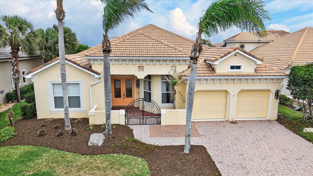 A single-story house with a tile roof, two-car garage, and a gated front courtyard — 17 ATLANTIC PLACE, PALM COAST, FL
