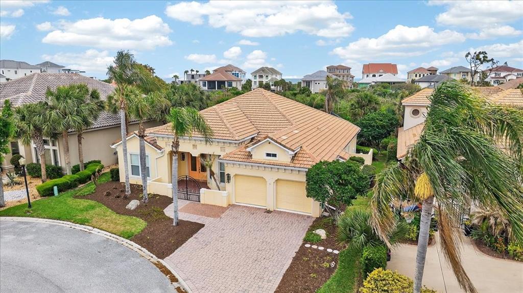 An aerial view shows a single-story house with a tile roof, two-car garage, and landscaping — 17 ATLANTIC PLACE, PALM COAST, FL