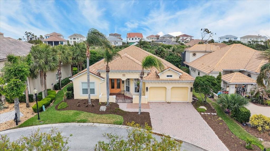 An exterior view of a single-story house with a tile roof and two-car garage — 17 ATLANTIC PLACE, PALM COAST, FL