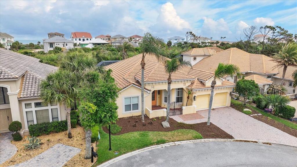 An elevated view of a tan, single-story house with a tile roof and paved driveway — 17 ATLANTIC PLACE, PALM COAST, FL
