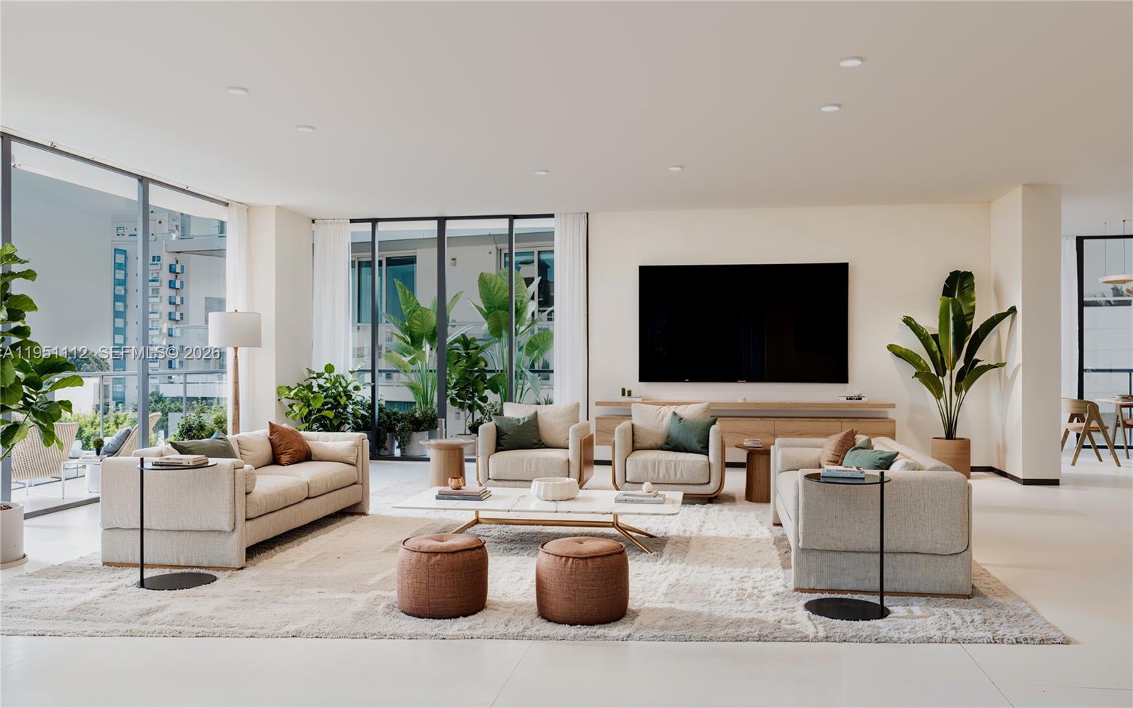 A modern living room features two sofas, two armchairs, a coffee table, and large windows — 1160 101 St # 601, Bay Harbor Islands FL 33154, BAY HARBOR ISLANDS, FL