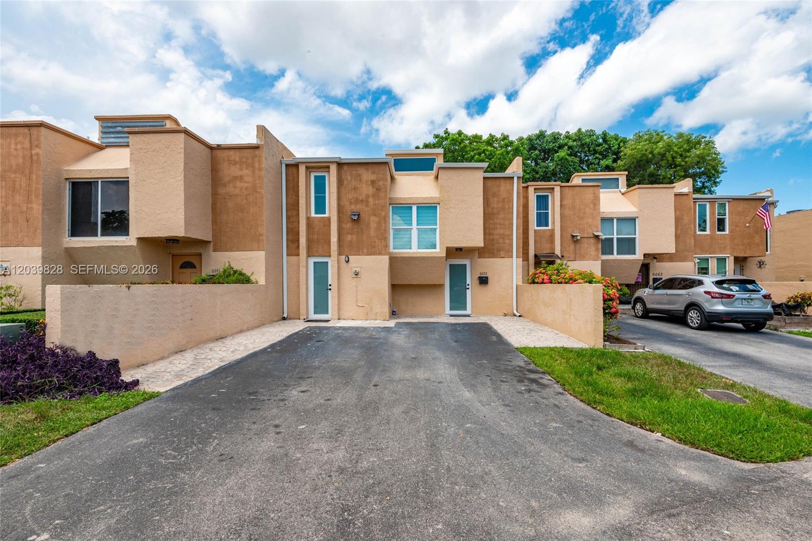 An aerial view shows a residential townhouse complex situated next to a lake and golf course — 6653 SW 140th Ave # 6653, Miami FL 33183, MIAMI, FL