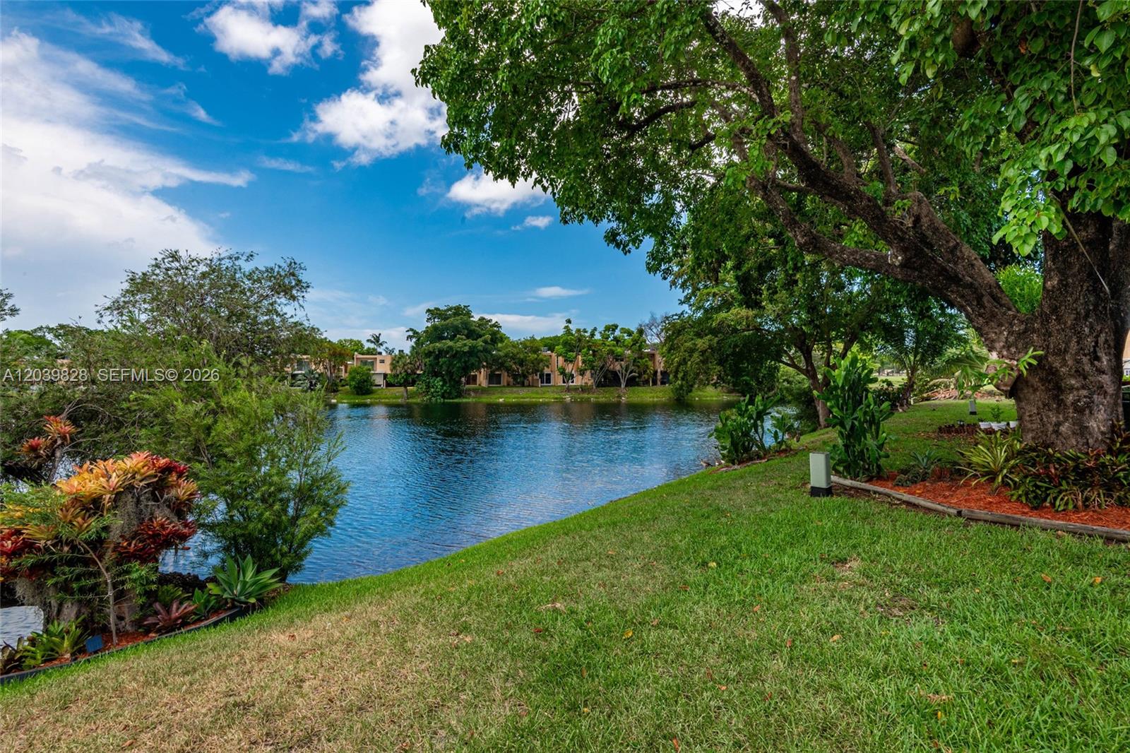 A row of multi-story townhouses with tan stucco exteriors and private asphalt driveways — 6653 SW 140th Ave # 6653, Miami FL 33183, MIAMI, FL