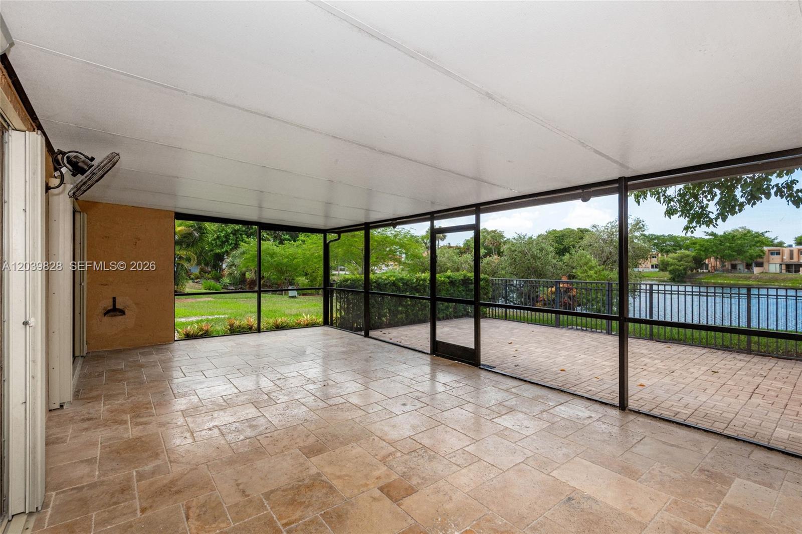 A grassy lawn slopes down toward a lake surrounded by trees and residential buildings — 6653 SW 140th Ave # 6653, Miami FL 33183, MIAMI, FL