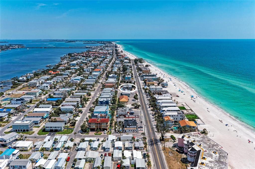 An aerial view shows a coastal neighborhood with a circled building near the beach — 101 25TH STREET N UNIT 3, BRADENTON BEACH, FL