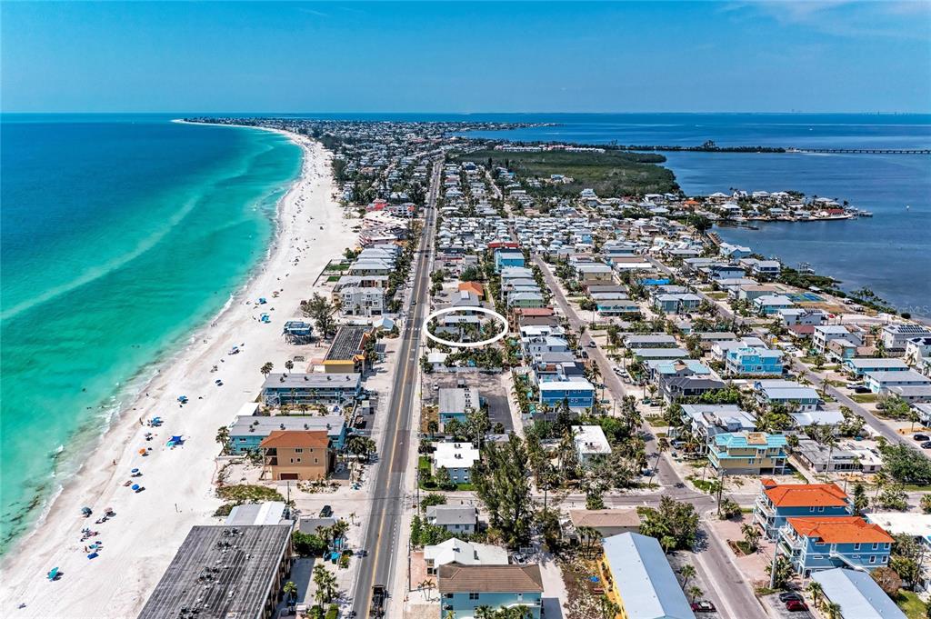 An aerial view shows a coastal town with a beach, road, and residential buildings — 101 25TH STREET N UNIT 3, BRADENTON BEACH, FL