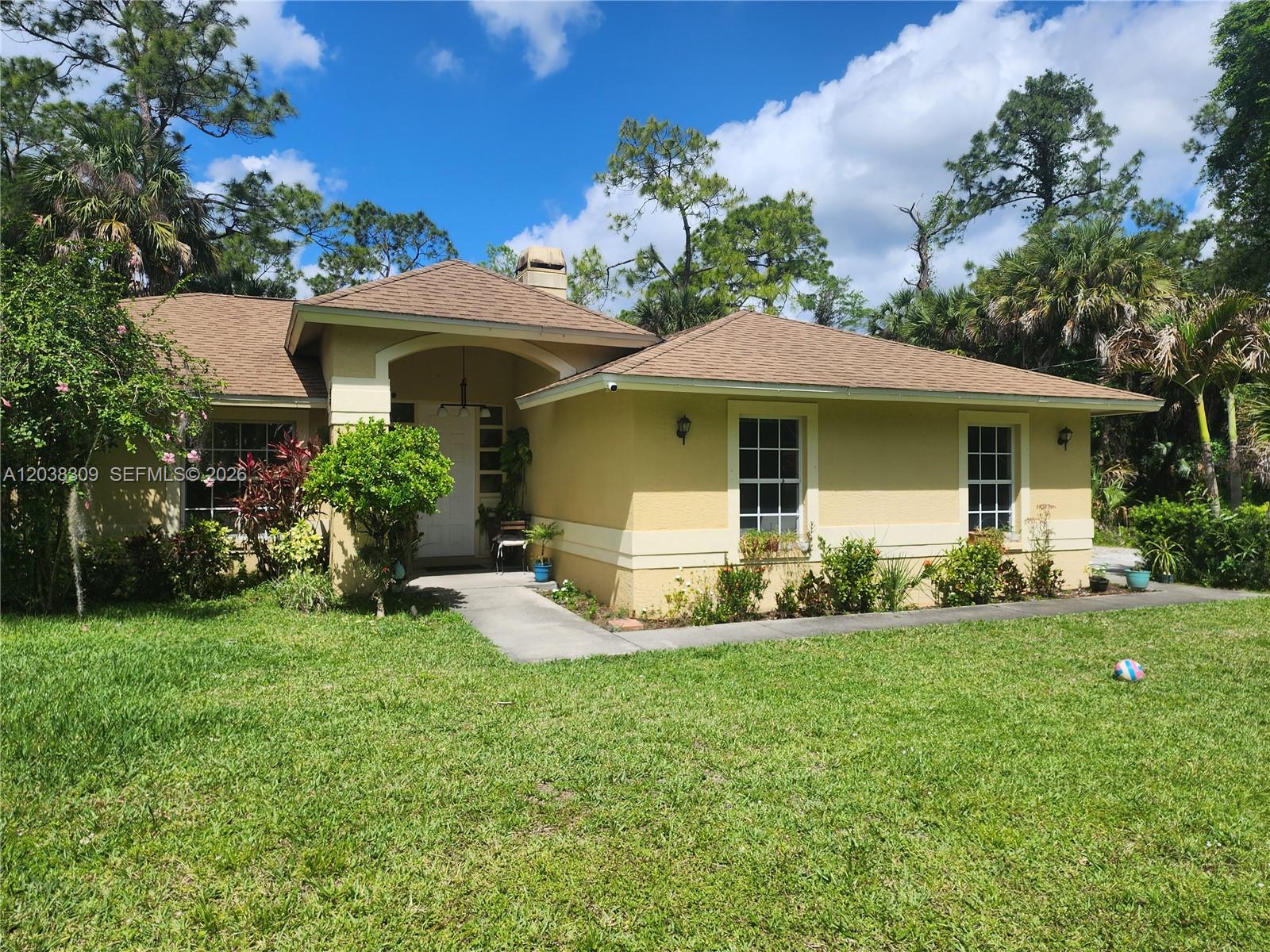 A single-story yellow house with a brown roof and a front walkway — 111 2ND ST SE, Naples FL 34117, NAPLES, FL