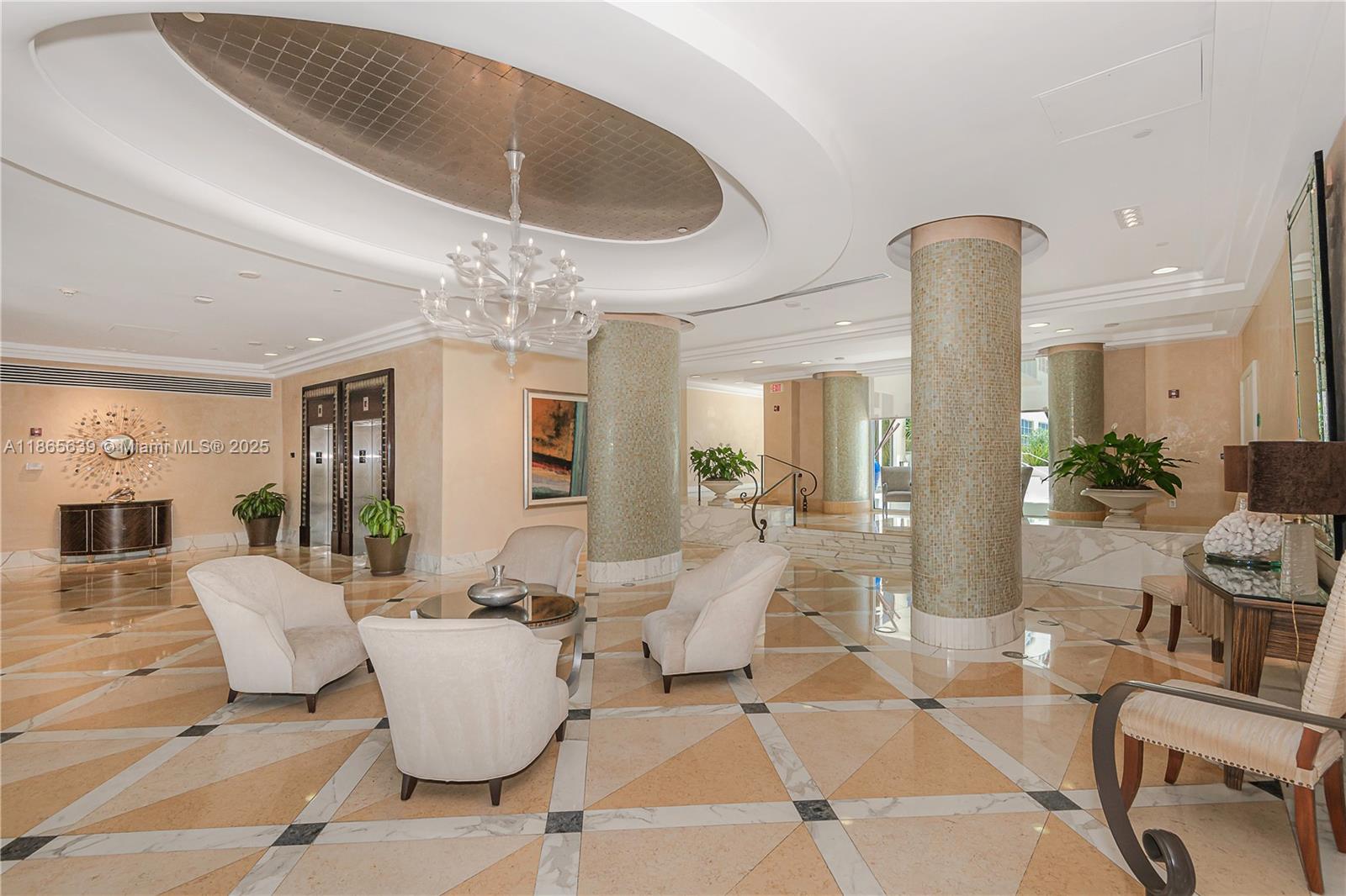 A lobby features a tiled floor, circular columns, a chandelier, and several armchairs — 6917 Collins Ave # 511, Miami Beach FL 33141, MIAMI BEACH, FL