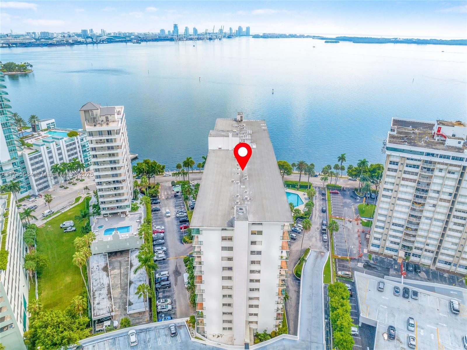 A kitchen features a white refrigerator, wood-grain cabinets, and tiled countertops with a sink — 1408 Brickell Bay Dr # 917, Miami FL 33131, MIAMI, FL