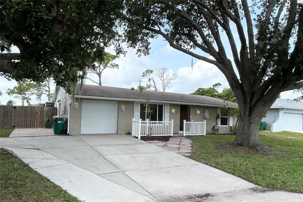 A single-story house with a white garage door, a front porch, and a concrete driveway — 4485 COSTELLO STREET, PORT CHARLOTTE, FL
