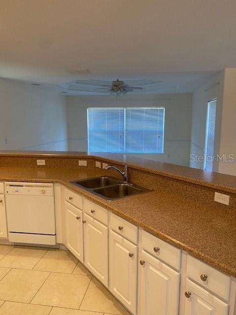 A kitchen features white cabinets, a double-basin sink, and a granite countertop breakfast bar — 28 FIRETHORN LANE, PALM COAST, FL