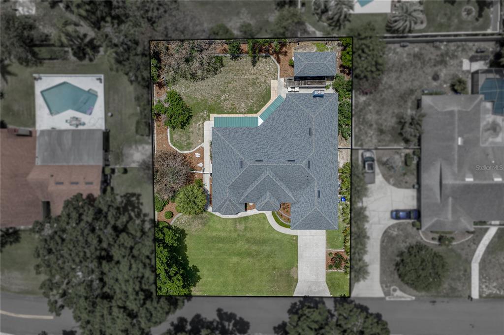 An aerial view shows a residential house with a gray roof and a concrete driveway — 1113 SUGARTREE DRIVE N, LAKELAND, FL