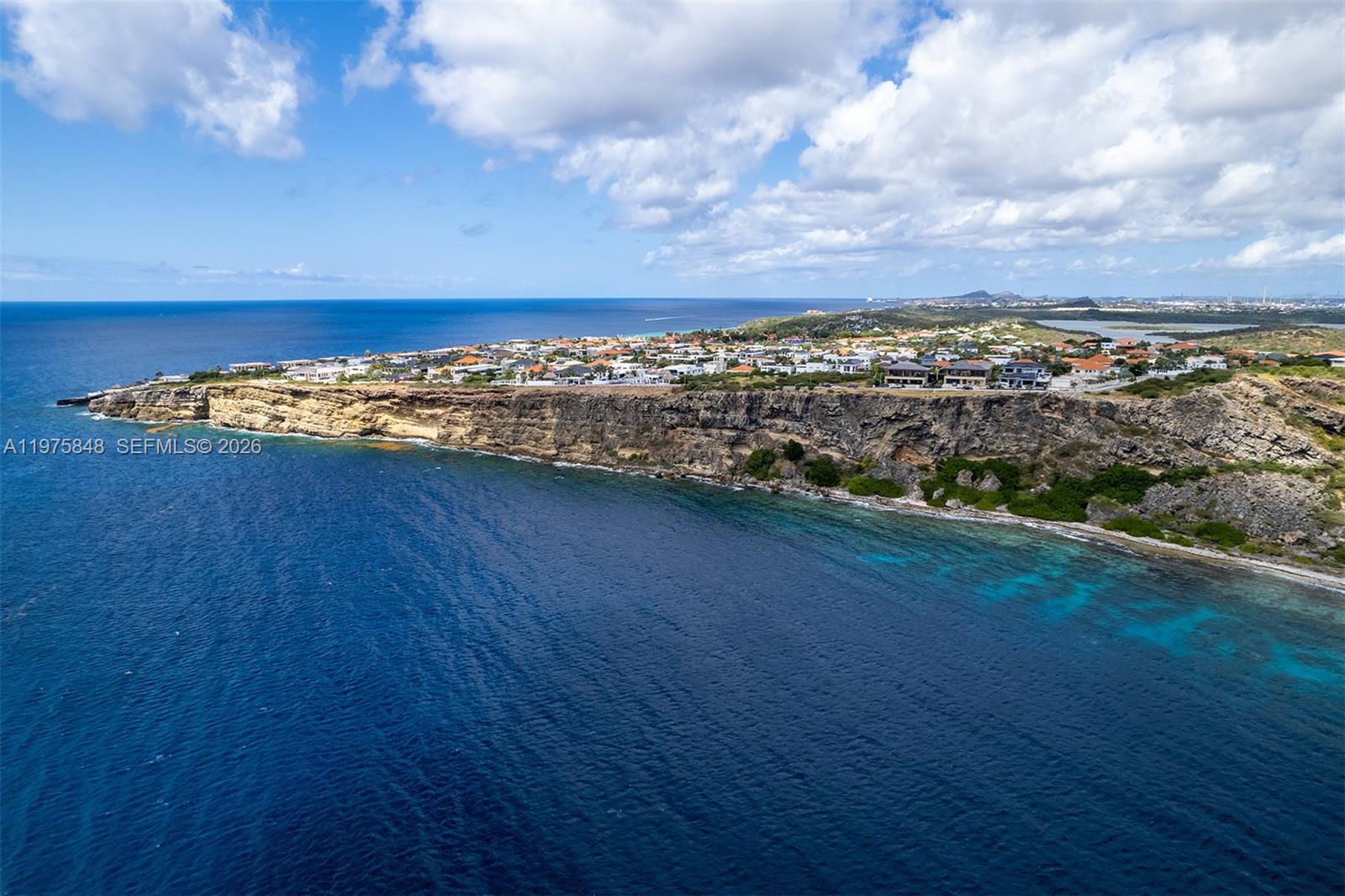 An aerial view shows a coastal cliffside residential neighborhood overlooking the Caribbean Sea — T17 Vista Royal, FL 0000, FL
