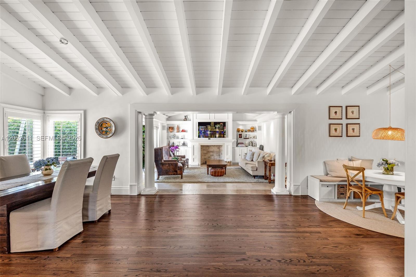 A dining area and breakfast nook open into a living room with a fireplace — 168 Morningside Dr, Coral Gables FL 33133, CORAL GABLES, FL
