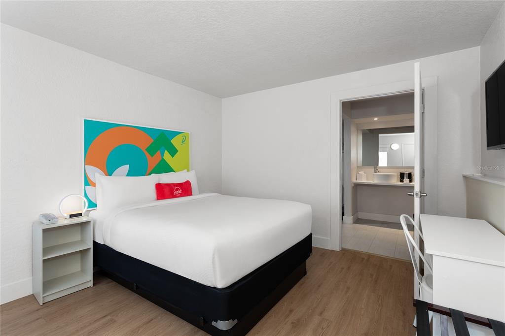A bedroom features a queen bed, a small nightstand, a desk, and an attached bathroom — 5367 W IRLO BRONSON MEMORIAL HIGHWAY UNIT 2-219, KISSIMMEE, FL