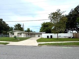 A single-story house with a white exterior, attached garage, and a white privacy fence — 2410 LANDO LANE, ORLANDO, FL