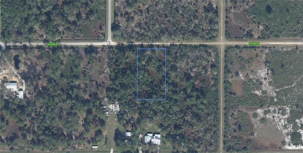 An aerial view shows a rectangular plot of land outlined in red next to a road — 2811 W STARR ROAD, AVON PARK, FL