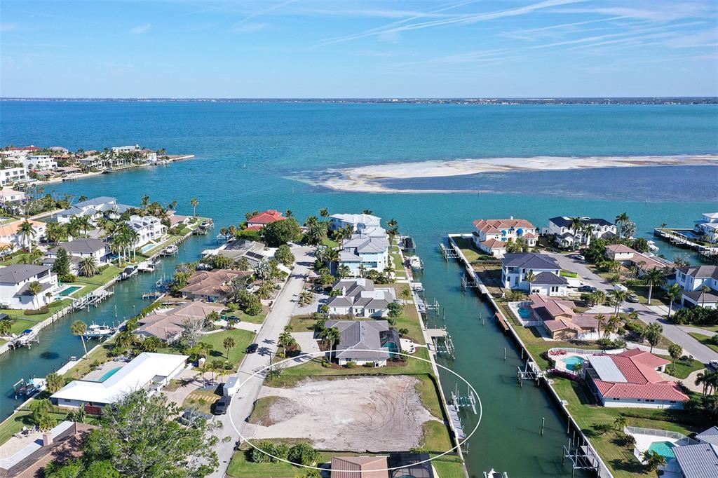 An aerial view shows a vacant waterfront lot situated between two residential canals — 536 GUNWALE LANE, LONGBOAT KEY, FL