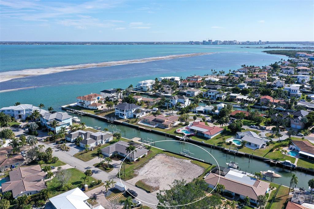 An aerial view shows a vacant waterfront lot circled in a residential neighborhood — 536 GUNWALE LANE, LONGBOAT KEY, FL