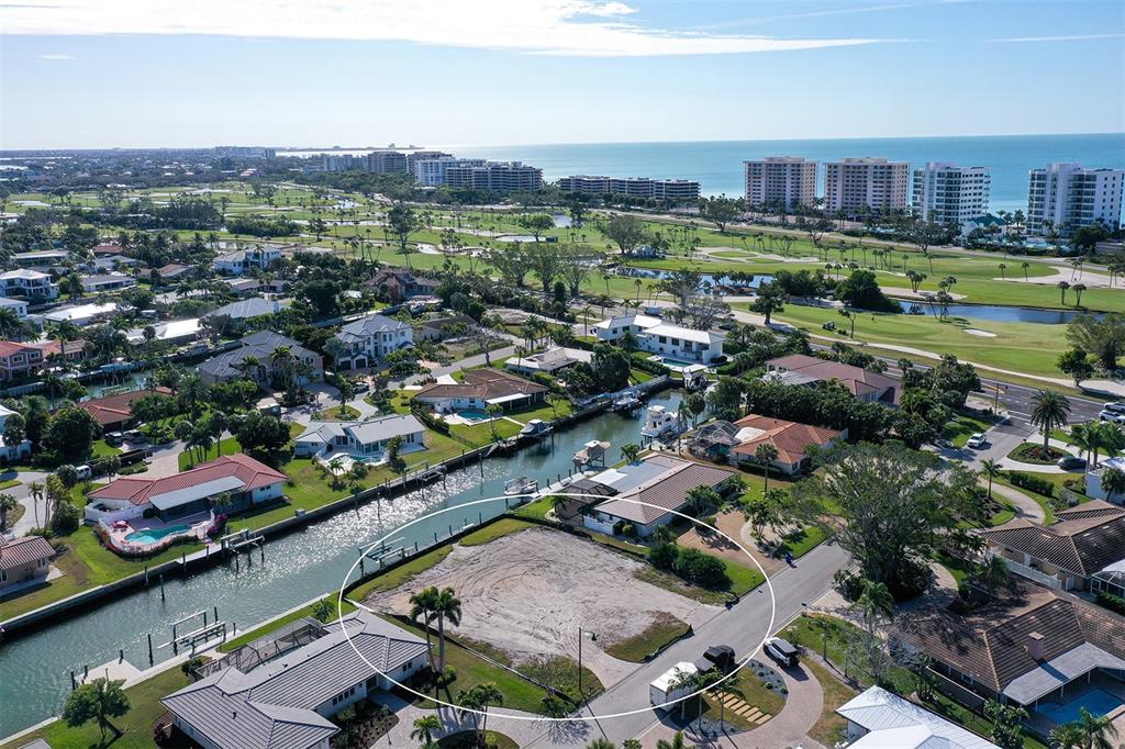 An aerial view of a vacant waterfront lot surrounded by residential homes and a golf course — 536 GUNWALE LANE, LONGBOAT KEY, FL
