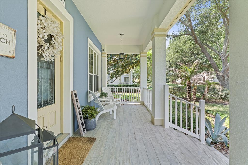 A two-story blue house with white shutters, a front porch, and a landscaped walkway — 11617 CAMDEN PARK DRIVE, WINDERMERE, FL