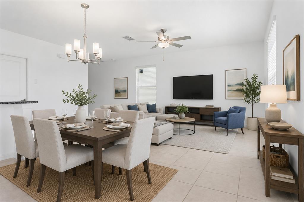 An open-concept living and dining area with neutral furniture, tile floors, and a ceiling fan — 11000 RADIANT SHORE LOOP, SAN ANTONIO, FL