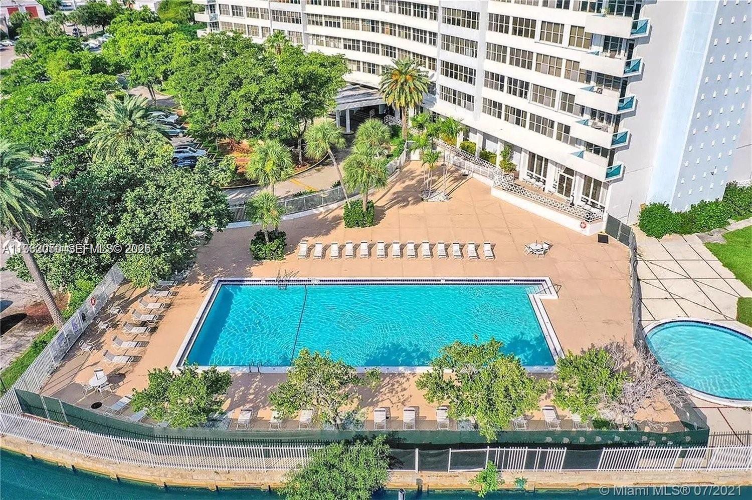 An aerial view shows a rectangular swimming pool and a circular hot tub outdoors — 7441 Wayne Ave # 9I, Miami Beach FL 33141, MIAMI BEACH, FL