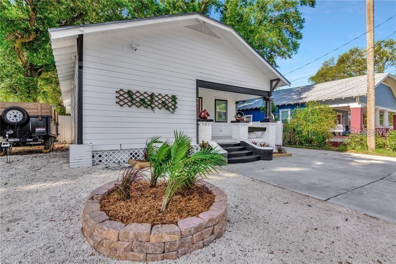 A white house with a front porch, a stone planter, and a gravel driveway — 705 E PLYMOUTH STREET, TAMPA, FL