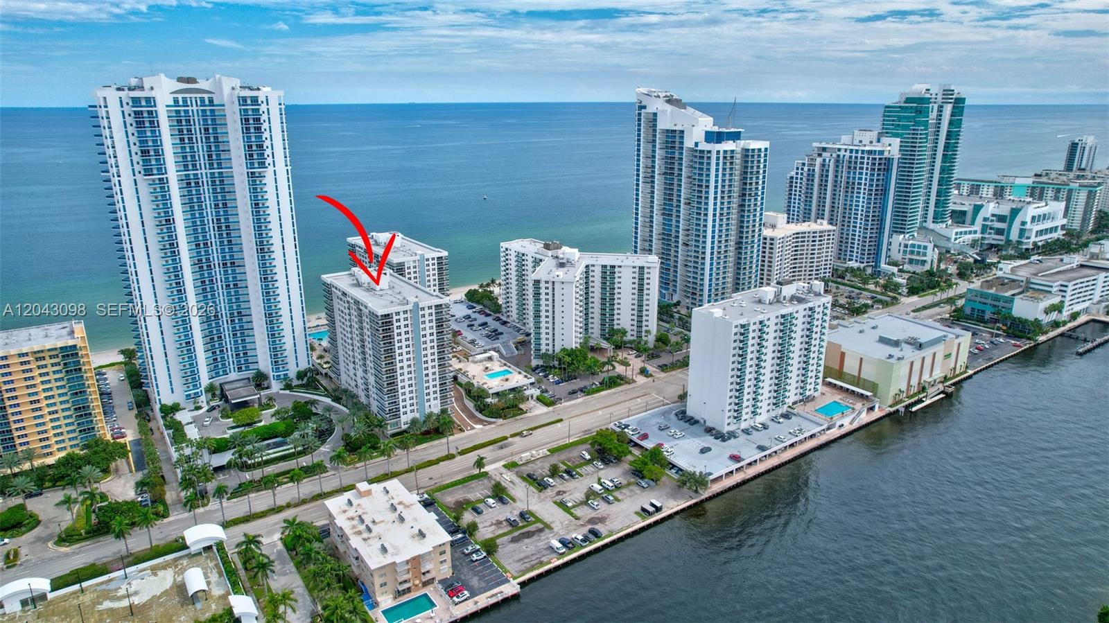 An aerial view shows a high-rise residential building marked with a red arrow — 2751 S Ocean Dr # 404N, Hollywood FL 33019, HOLLYWOOD, FL