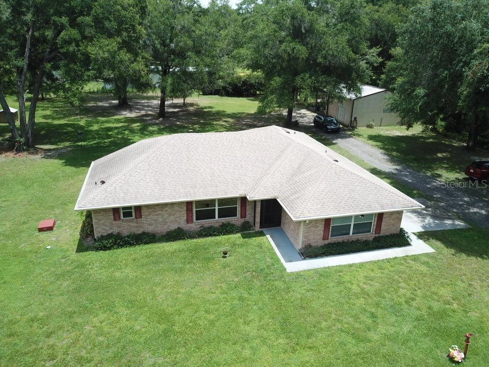 An aerial view of a single-story brick house with a light-colored roof and lawn — 267 N ORANGE AVENUE, LAKE HELEN, FL