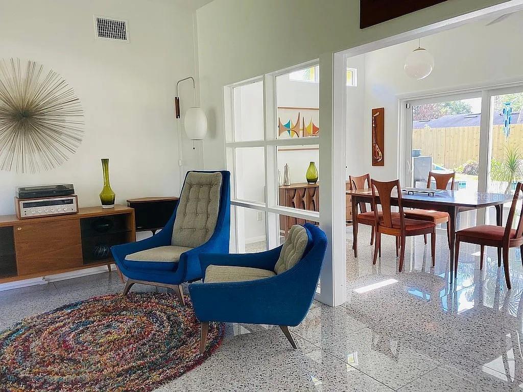A single-story lime green house with a flat roof and a concrete driveway — 1402 CUMBIE STREET, ORLANDO, FL
