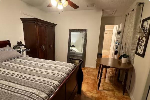 A bedroom features a wooden bed frame, a large wardrobe, a floor mirror, and a table — 2306 Liberty St # C, Hollywood FL 33020, HOLLYWOOD, FL