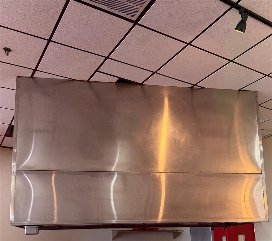 A large stainless steel commercial exhaust hood is mounted on a drop ceiling — 3042 W SAND LAKE ROAD, ORLANDO, FL